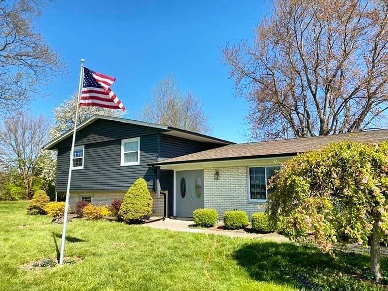 A house with an american flag flying in front of it.