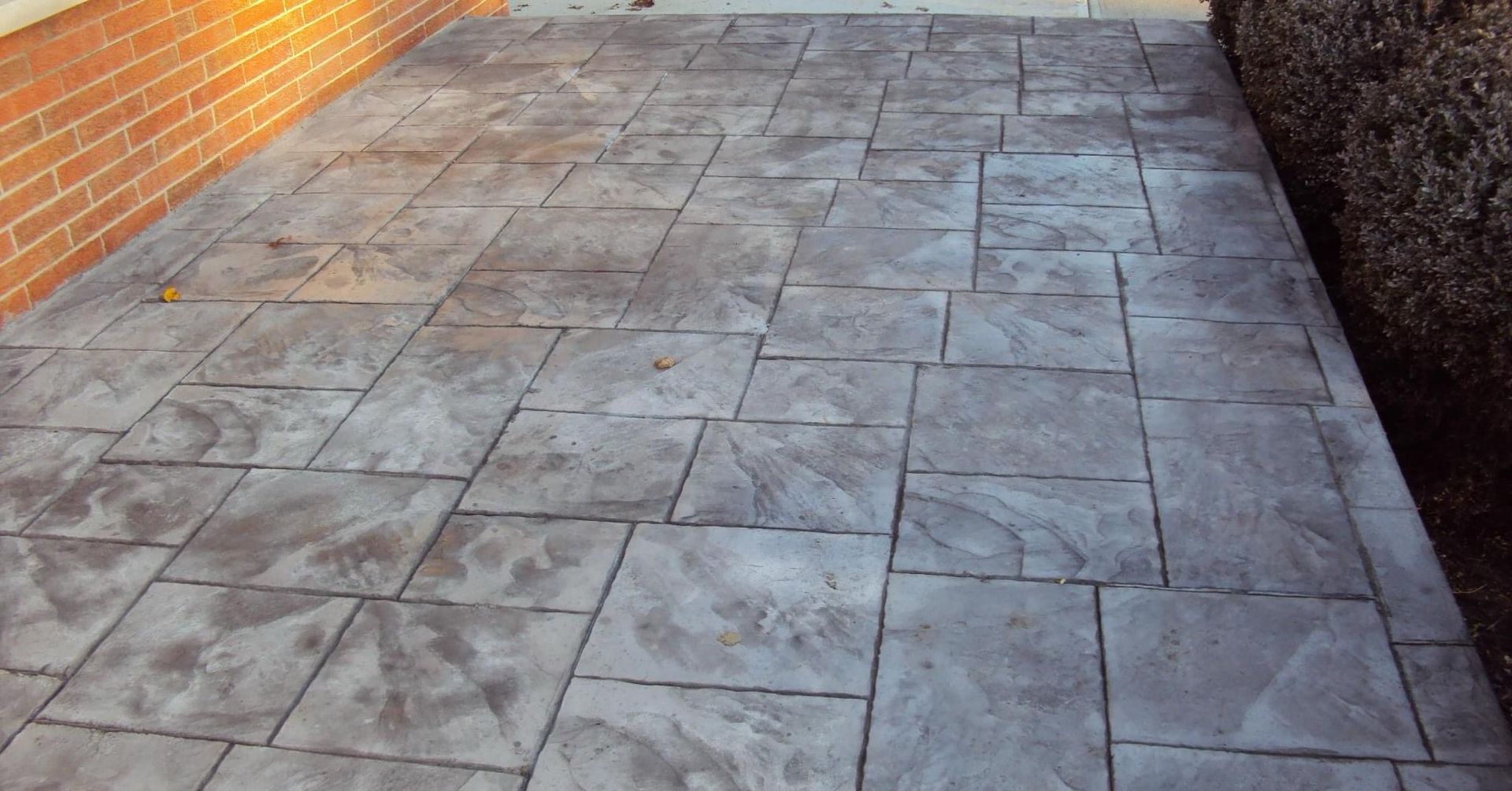 A person is plastering a wall with a trowel.