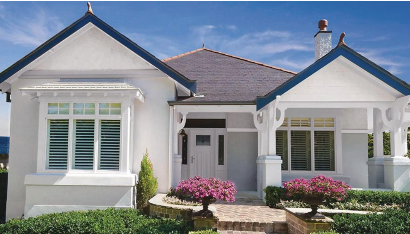 White paint peeling off weathered wooden siding.