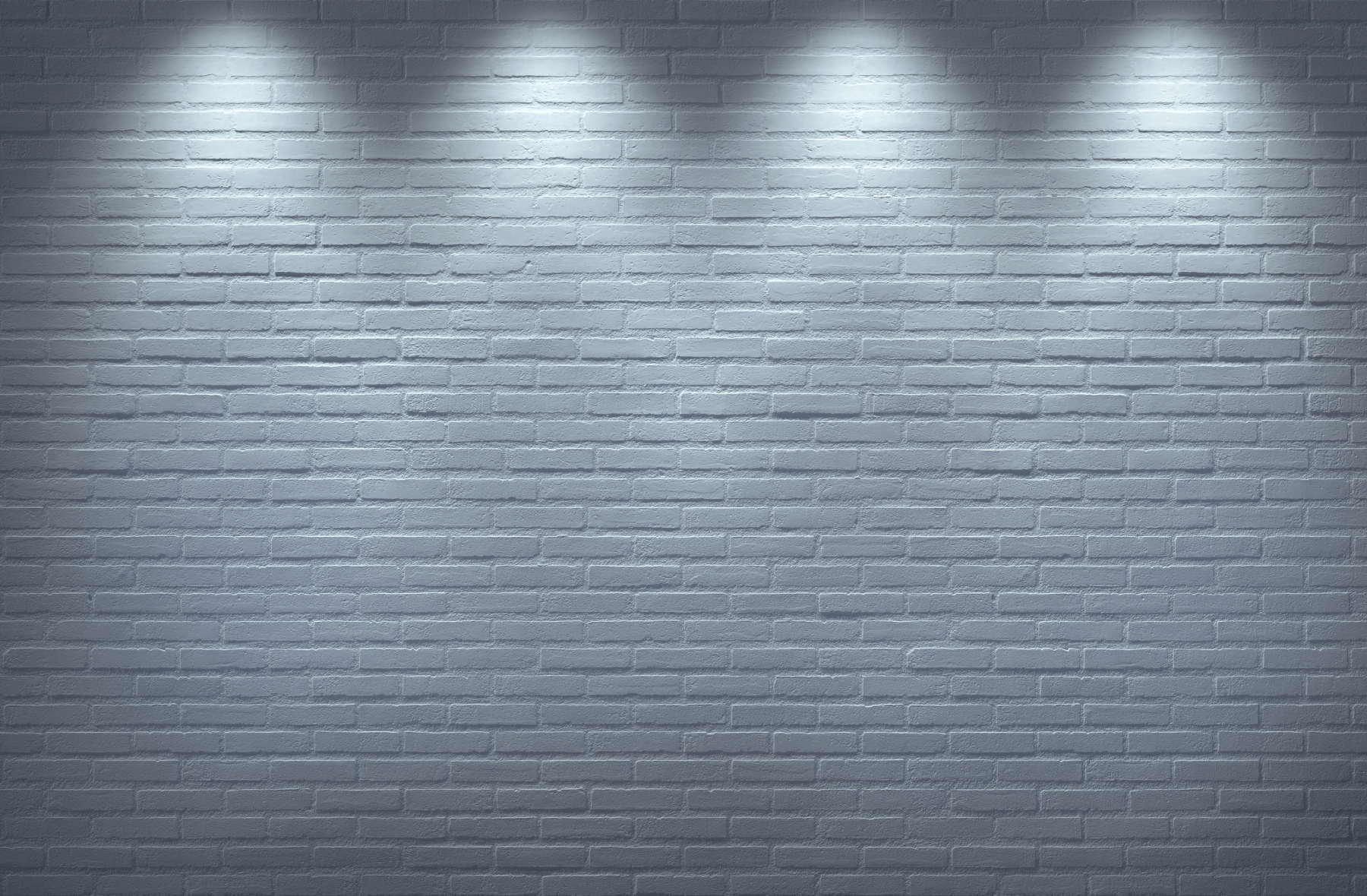 A brick wall with a row of lights on it.