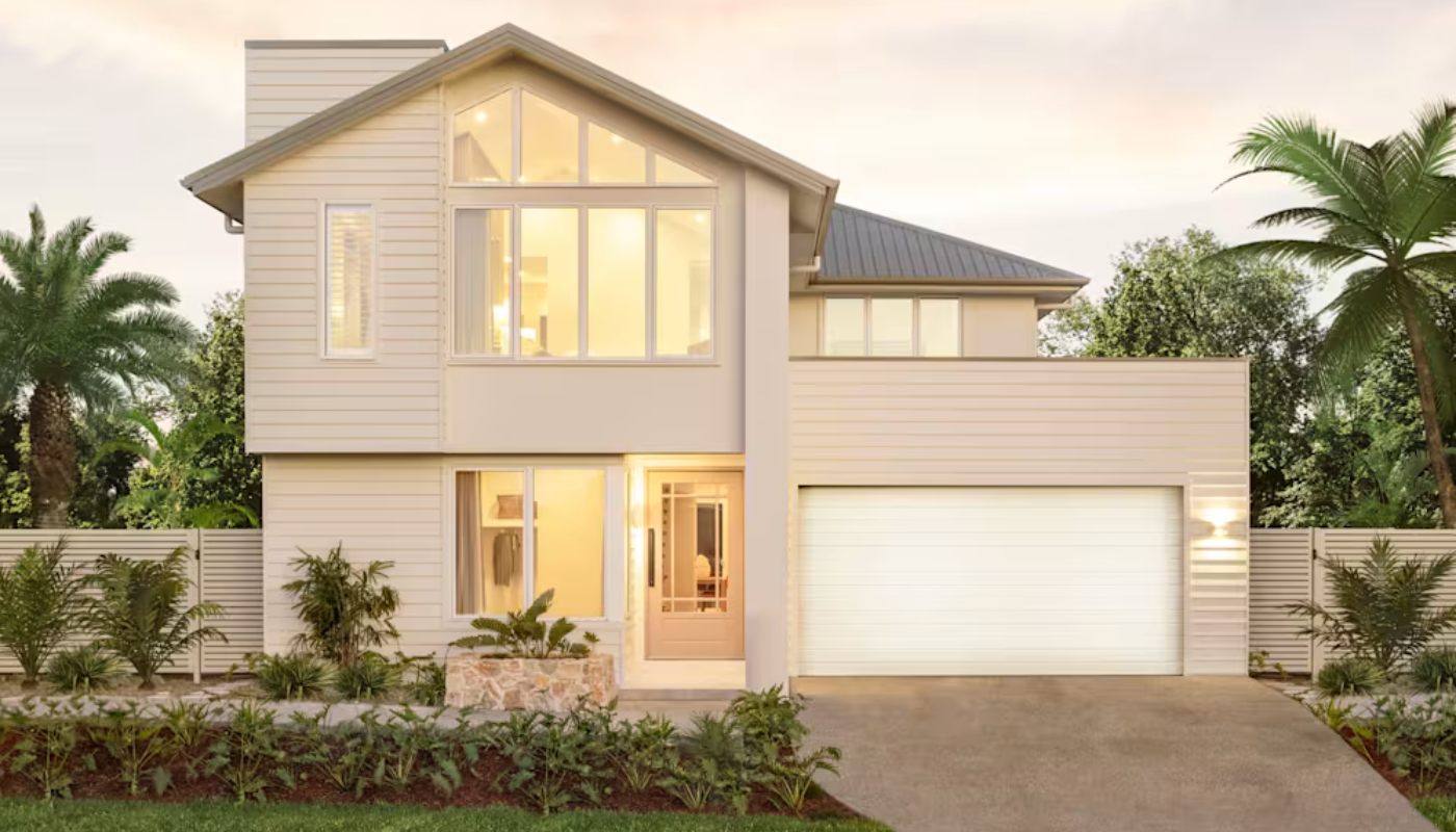 Two-story house with a white exterior, garage, and large windows, surrounded by landscaping, trees, and a light sky.