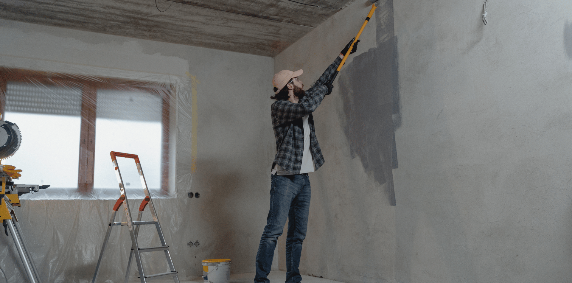 A tradesman painting a driveway