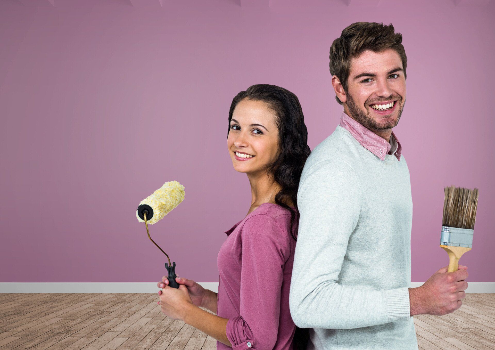 Young couple preparing a wall for painting