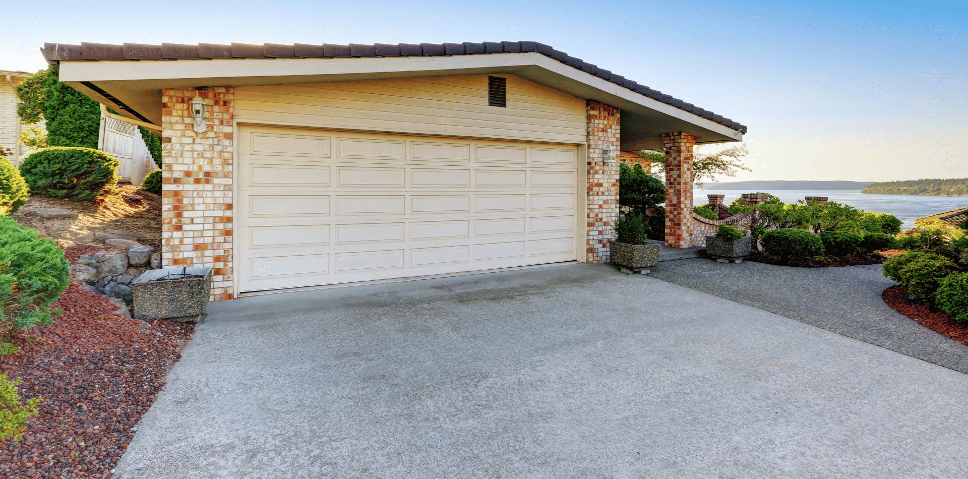 A freshly painted driveway to a garage.