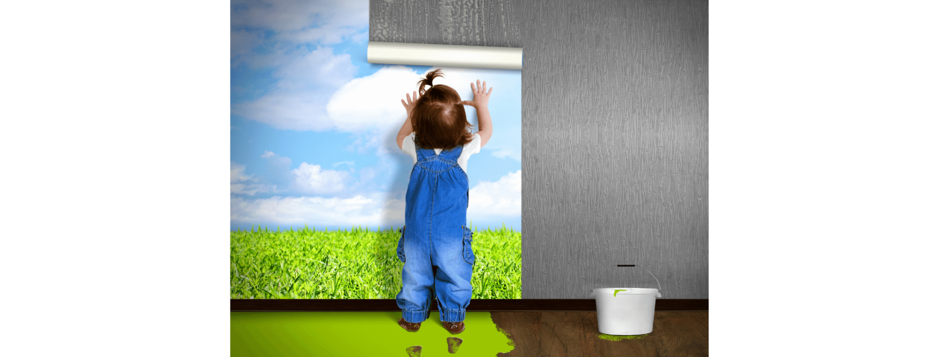 Young child hanging wallpaper