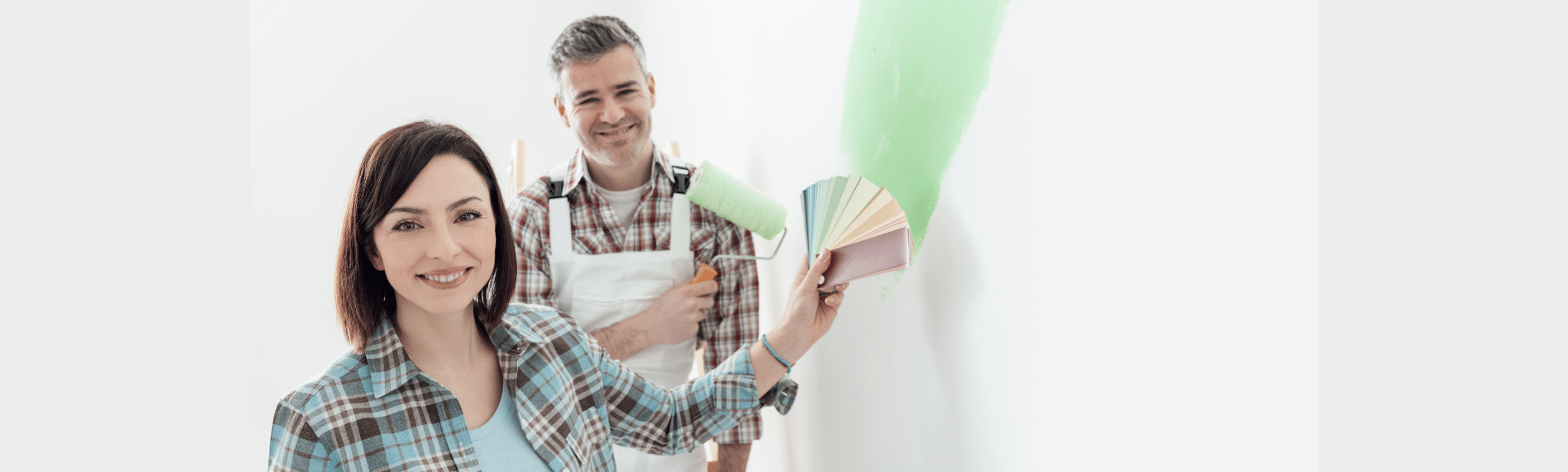 A man and woman choosing paint color