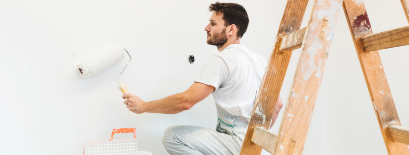 professional painter painting a wall