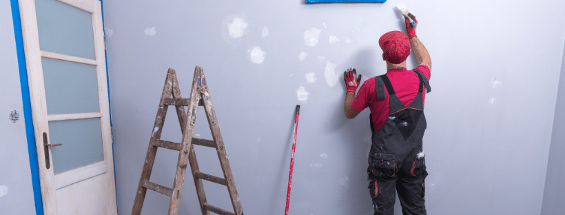 professional painter preparing a wall for paint