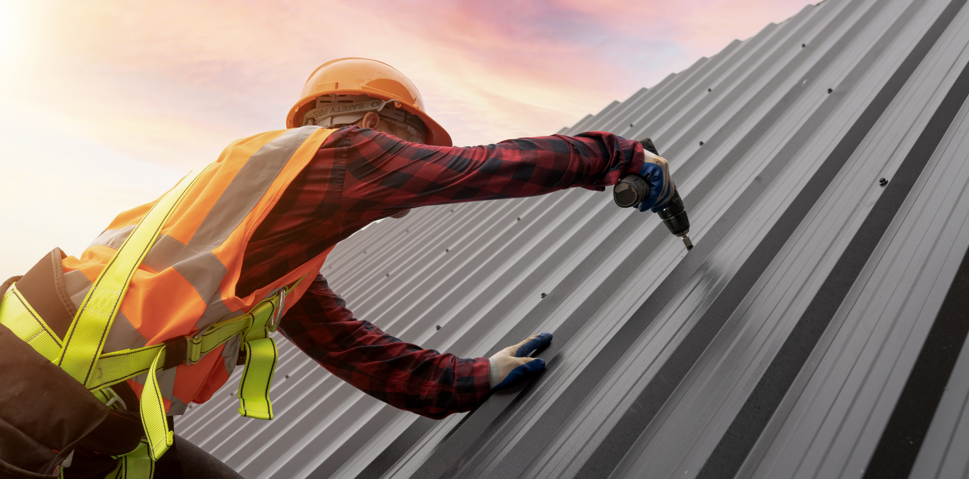 Tradesman installing a metal roof