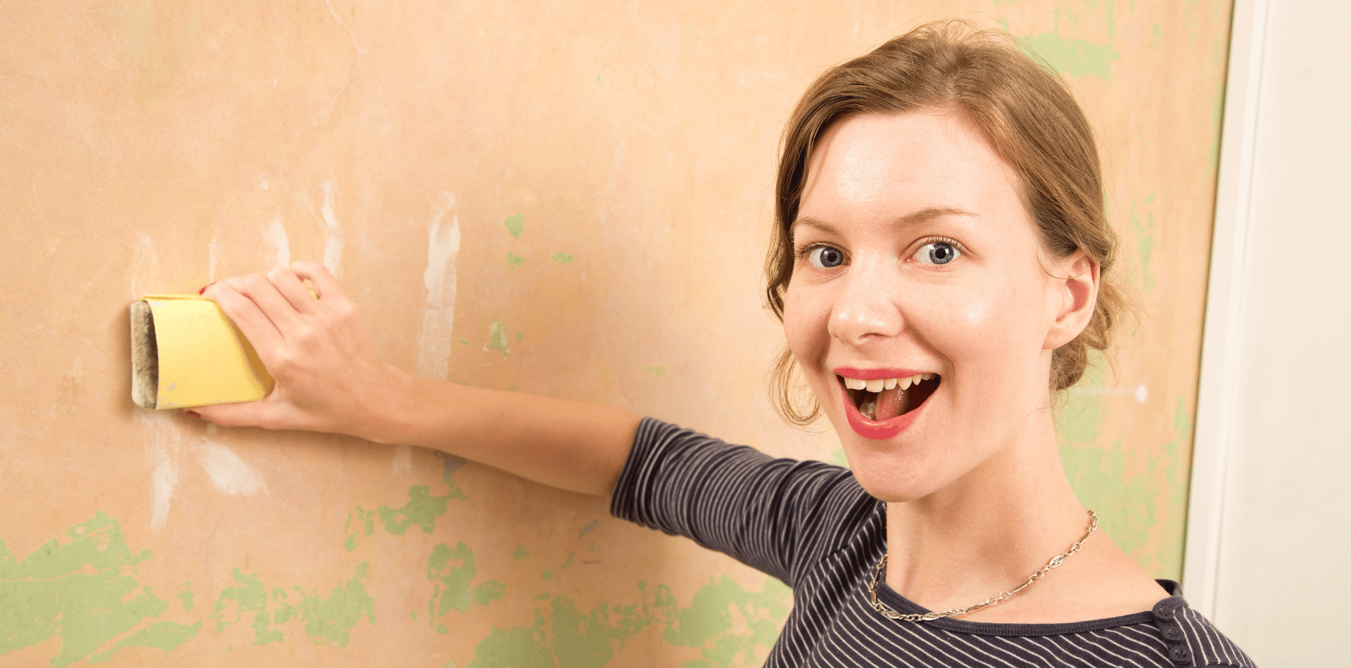 Woman preparing a wall for painting
