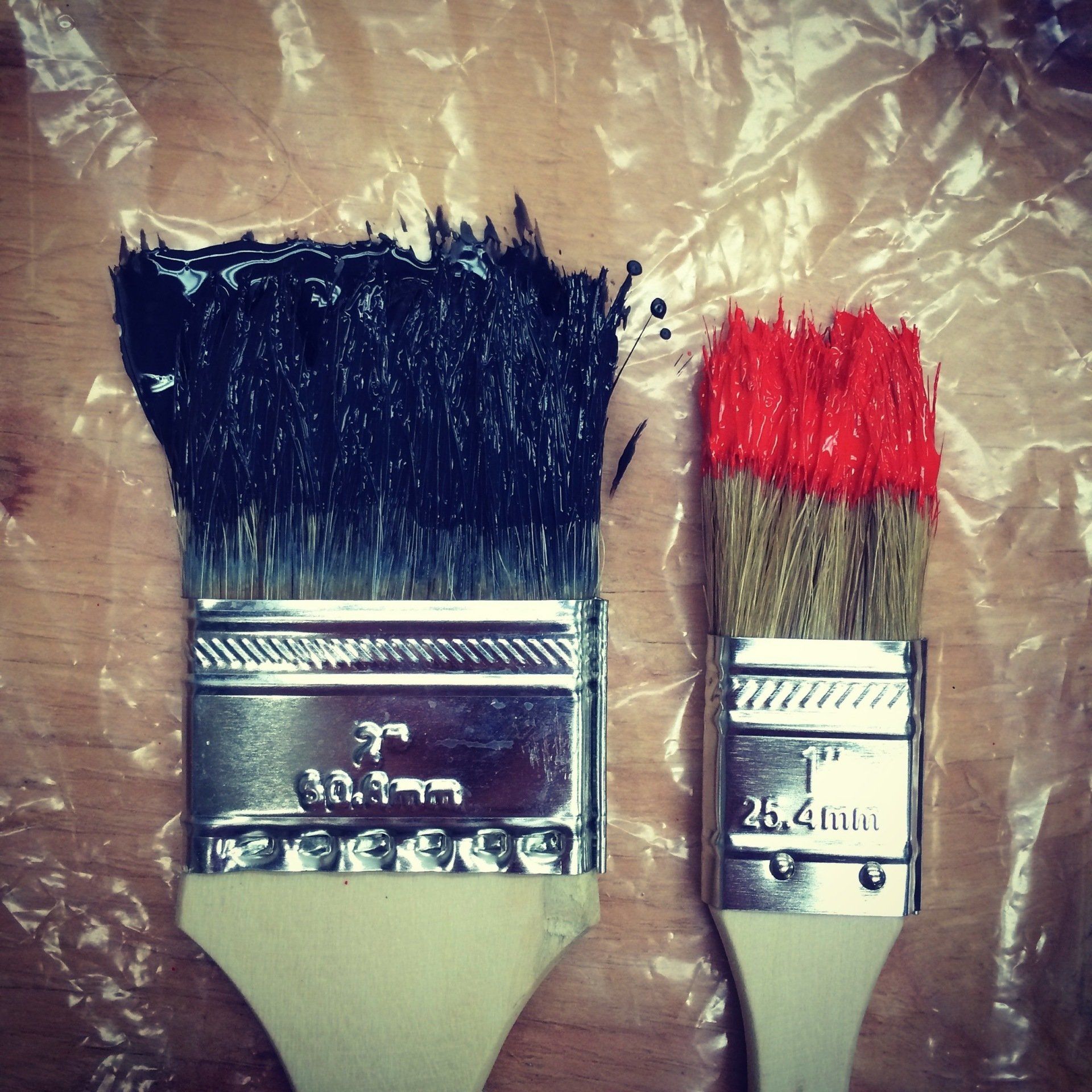 Paint brushes wrapped in plastic for storage