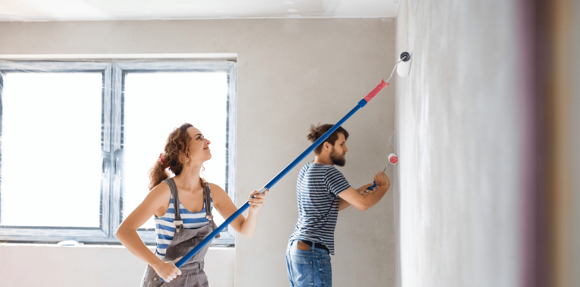 Young couple painting a wall