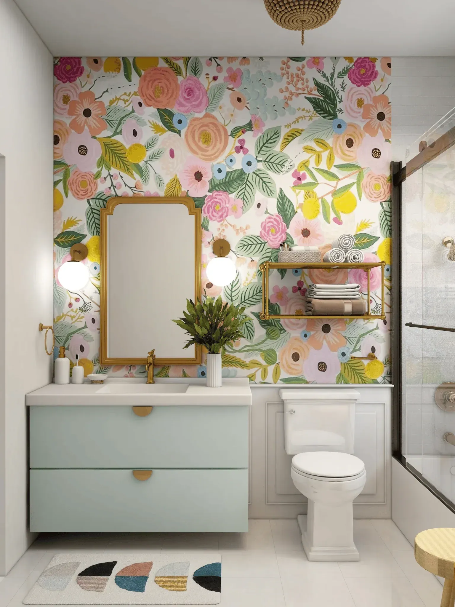 Bathroom with floral wallpaper, a light blue vanity, gold accents, and a white toilet.