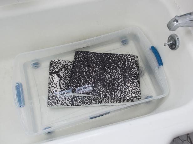 Soaking wallpaper in a tub before applying
