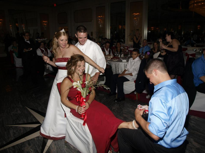 A group of people are dancing at a wedding reception