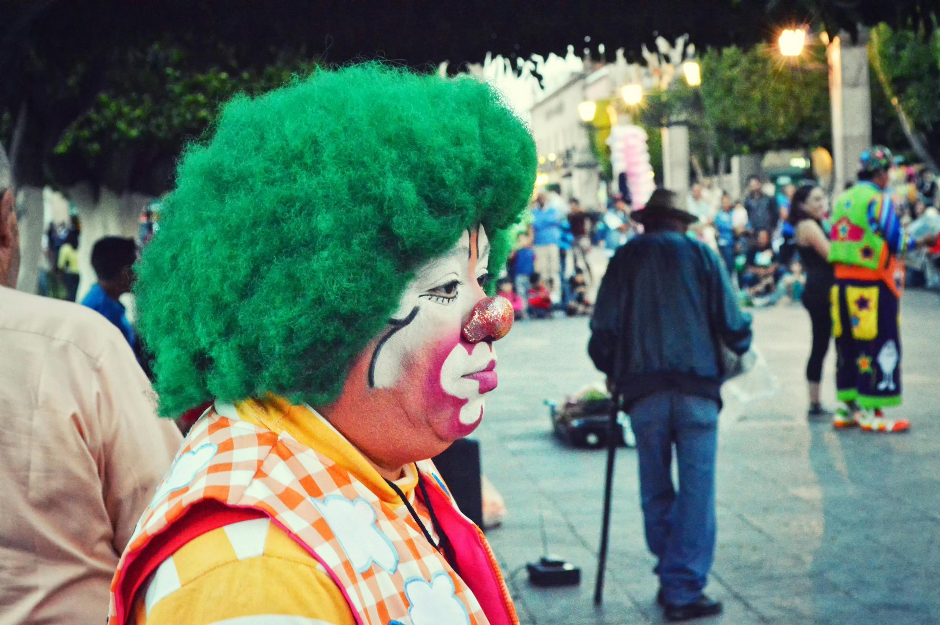 A man dressed as a clown with the number 19 on his outfit