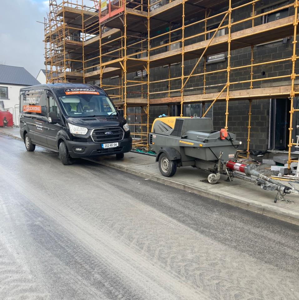 A van is parked on the side of the road next to a trailer