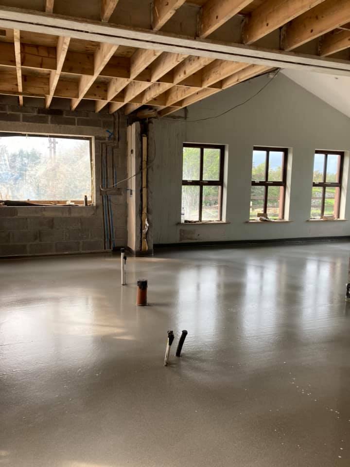 A large empty room with a lot of windows and a wooden ceiling.
