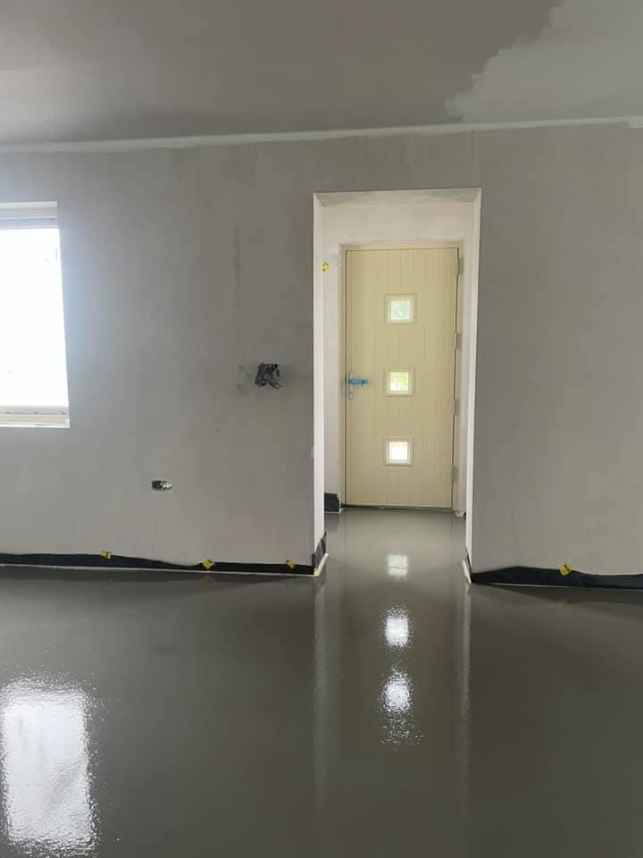 A living room with a doorway leading to a hallway.