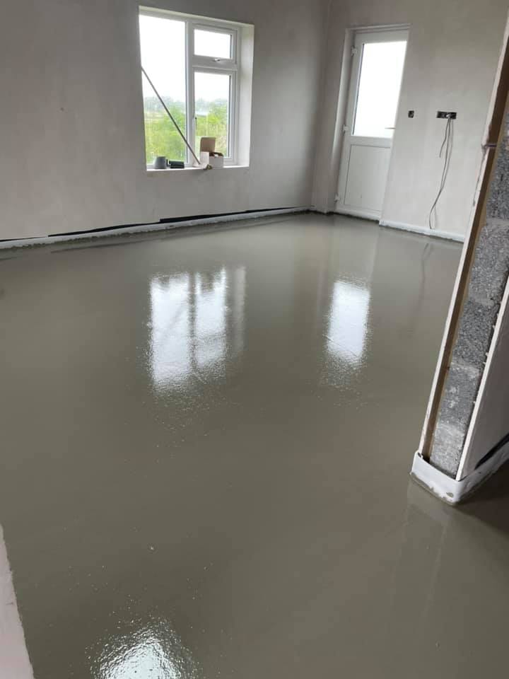 A room with a concrete floor and a window.