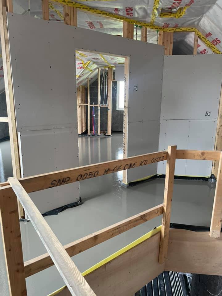 A room under construction with a wooden railing.