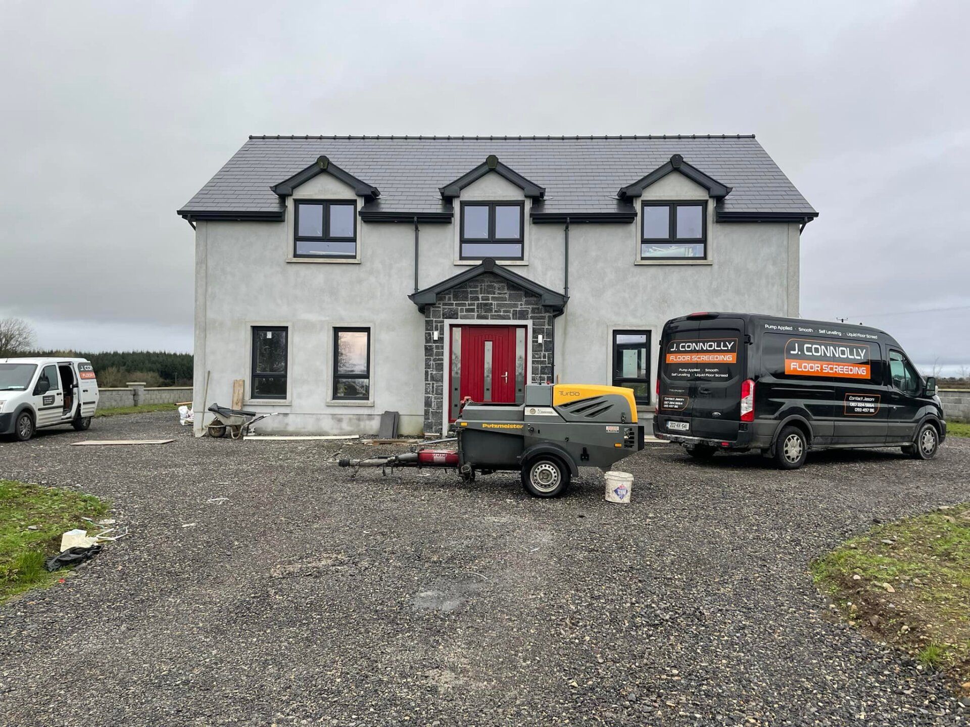 A house with two vans parked in front of it.