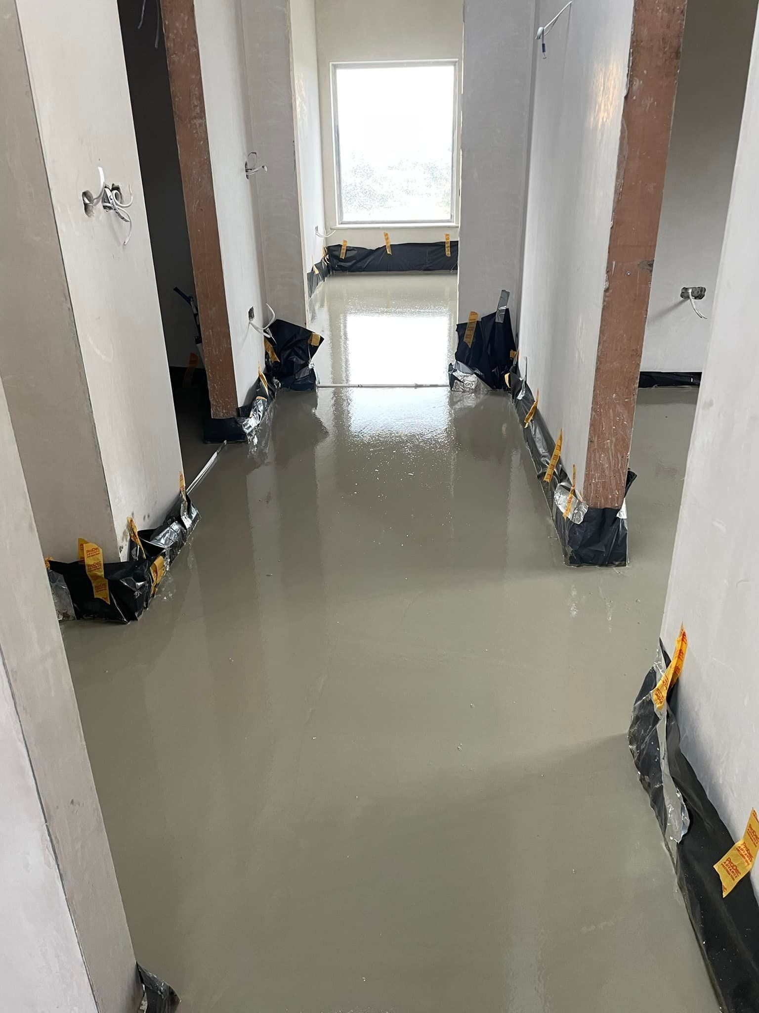 A hallway with a lot of concrete on the floor.
