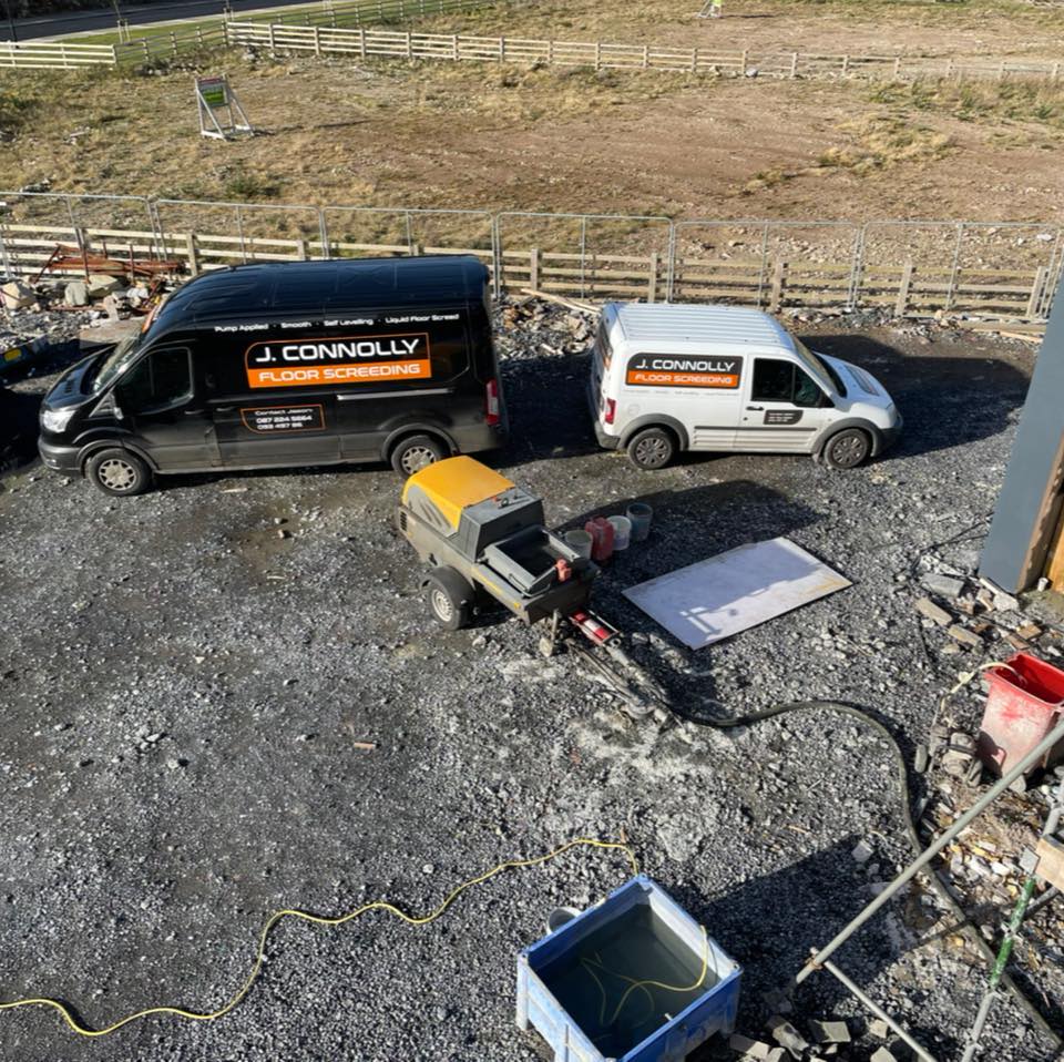 Two connolly vans are parked in a gravel lot