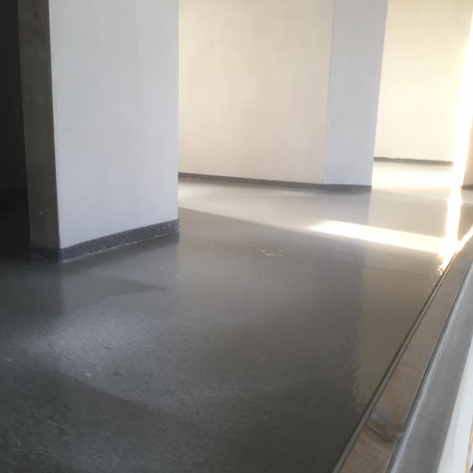 A room with a gray floor and white walls.