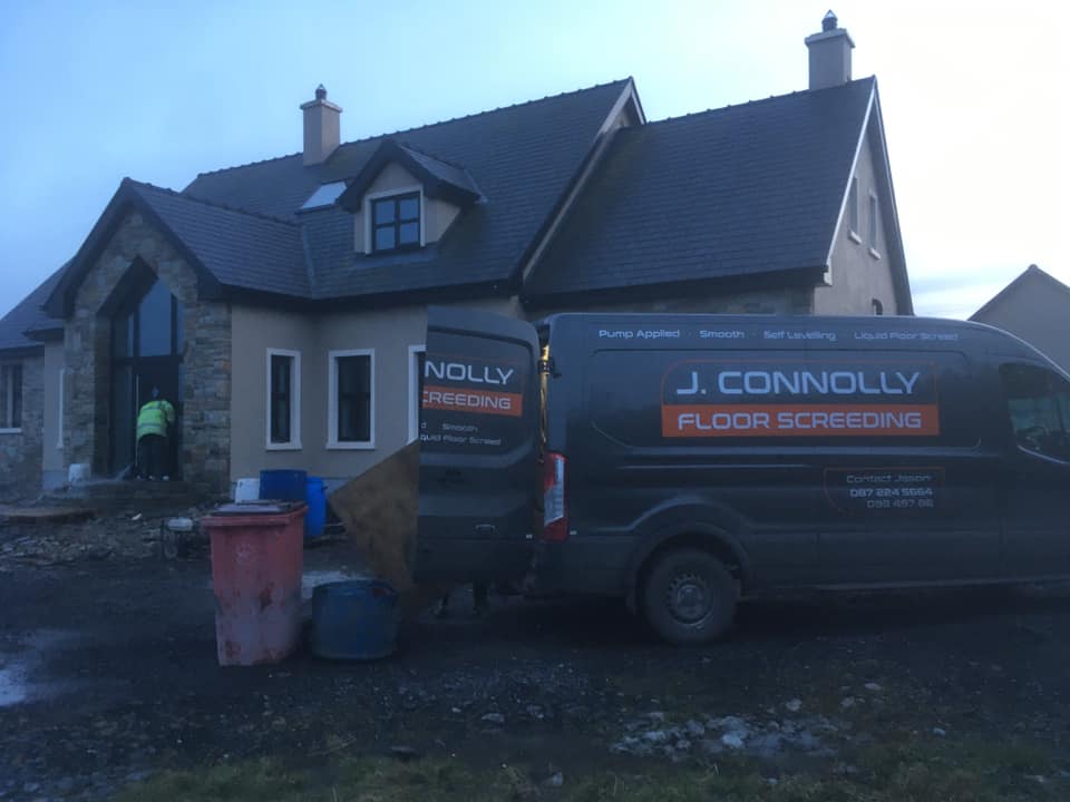 A j. connolly van is parked in front of a house