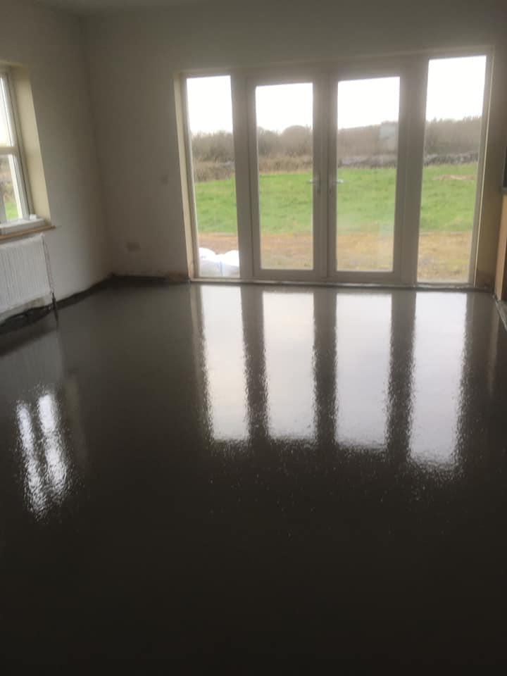 A room with a lot of windows and a reflection of the windows in the floor.