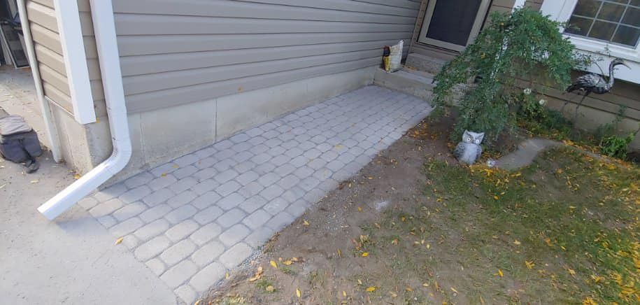 A sidewalk is being built in front of a house.