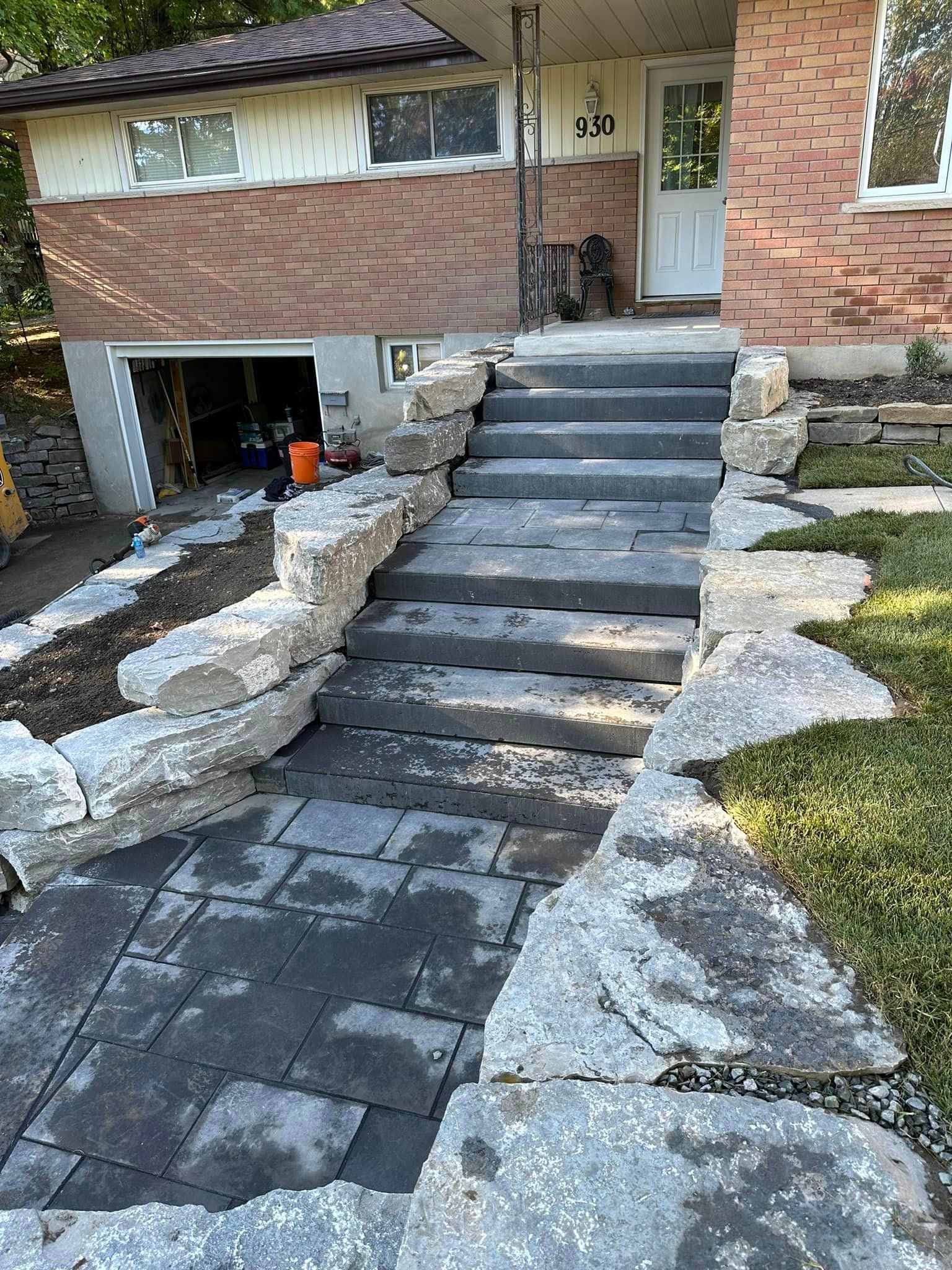 A set of stairs leading up to a brick house.