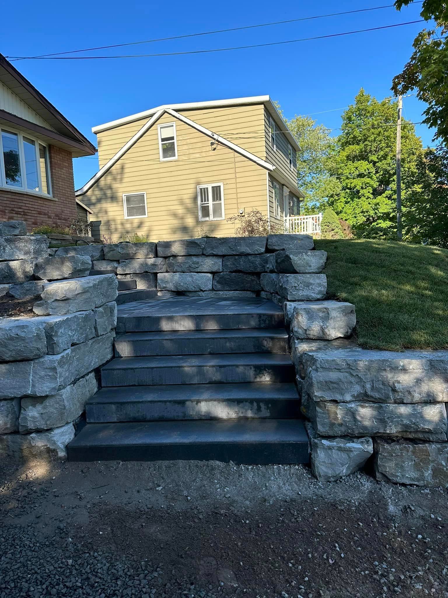 A set of stone stairs leading up to a house.