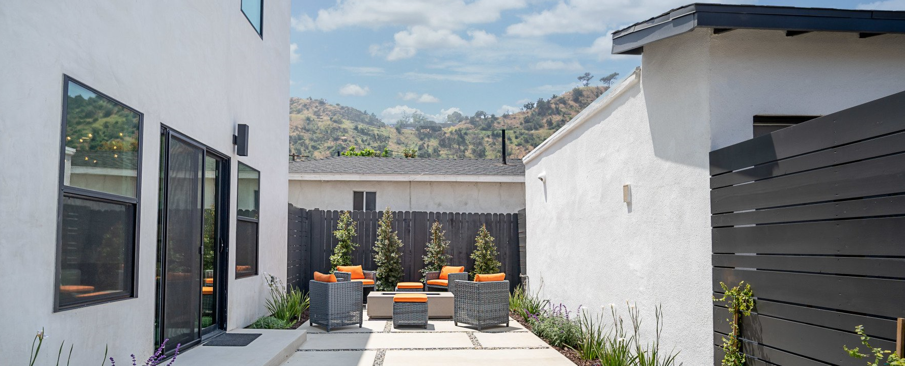Reclaimed side yard converted into quaint outdoor patio for accessory dwelling unit (ADU) backyard home.