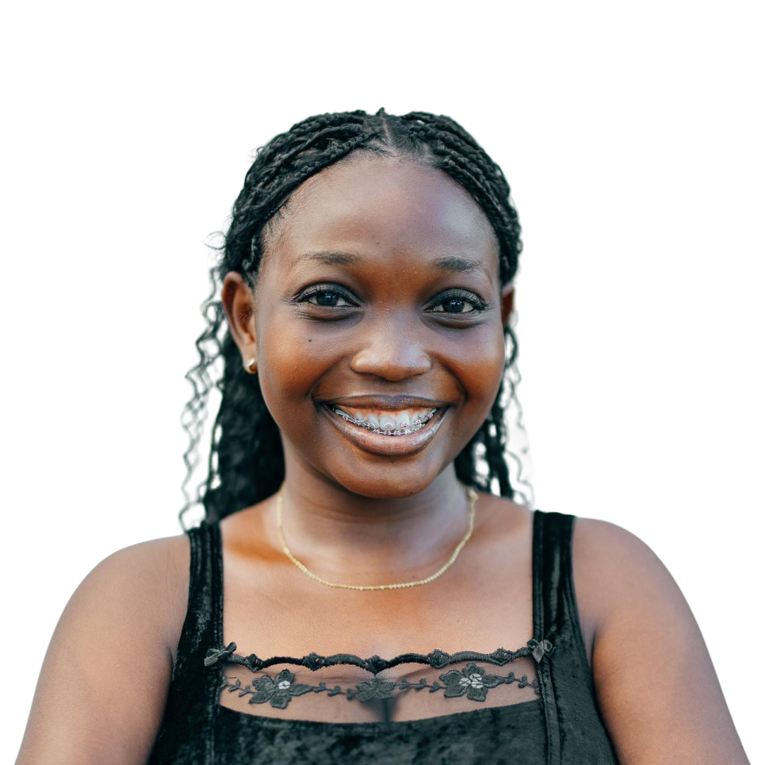 A woman in a black tank top is smiling with her arms crossed