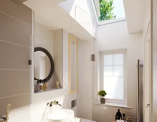 Bright bathroom with skylight, shower, sink, round mirror, and a small window.