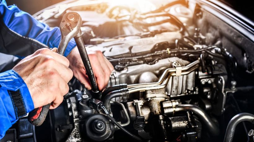 Car Mechanic Opening a Car Engine