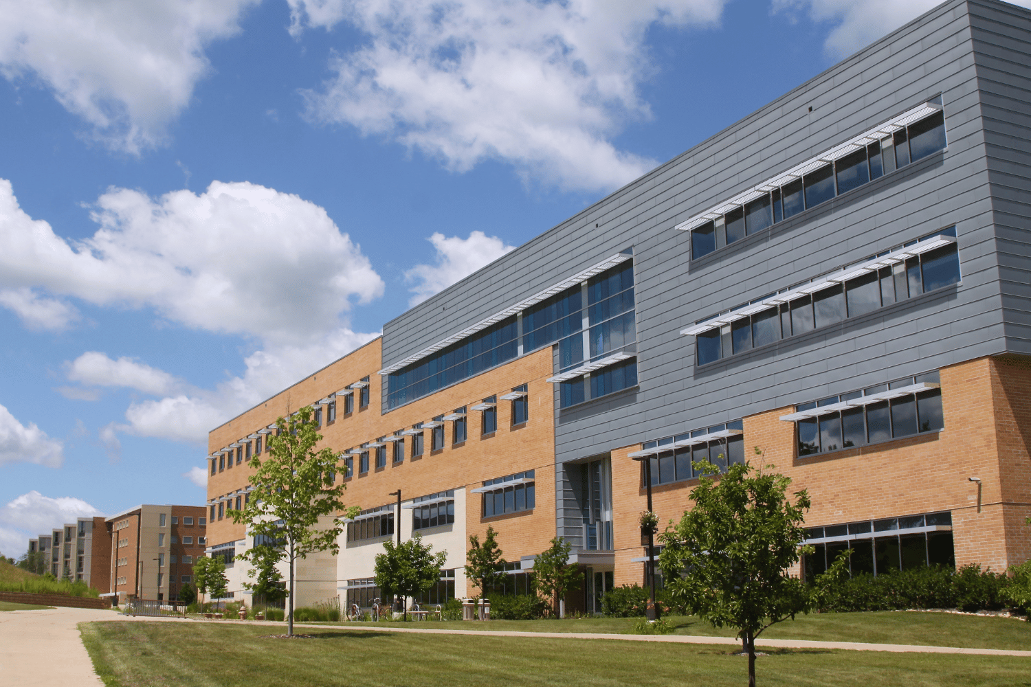 A large building with a lot of windows and trees in front of it