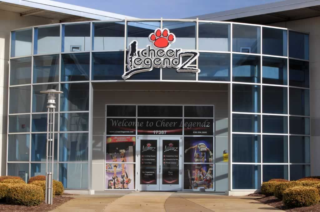 A large glass building with a sign that says cheer legendz
