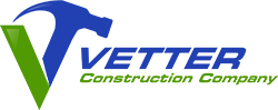 A blue and green logo for vetter construction company