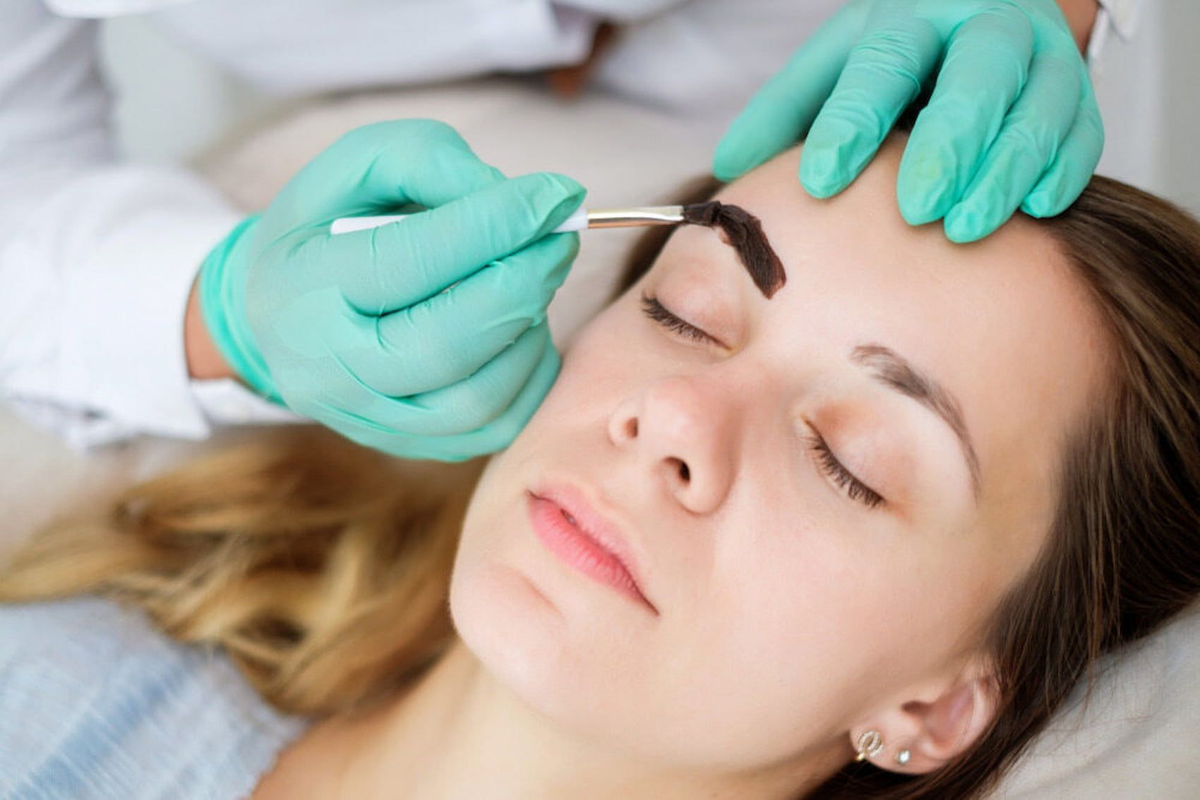 A Woman Is Getting Her Eyebrows Dyed In A Beauty Salon — InHarmony Skin & Beauty Clinic In The Entrance, NSW