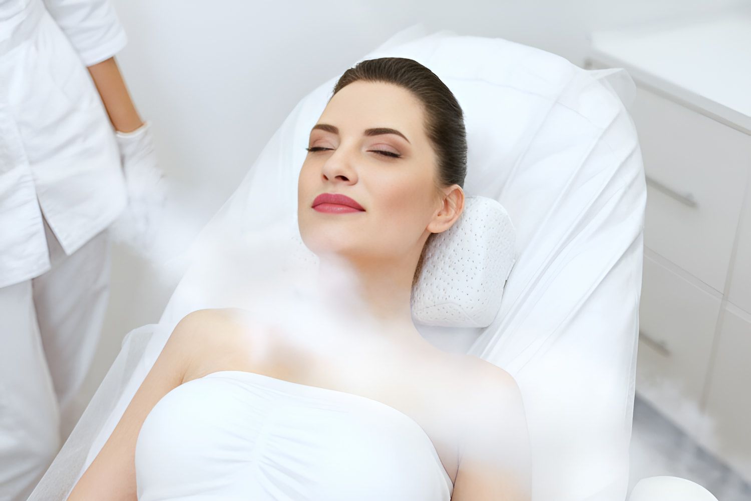 A Woman Is Laying In A Bed With Steam Coming Out Of Her Face — InHarmony Skin & Beauty Clinic In The Entrance, NSW