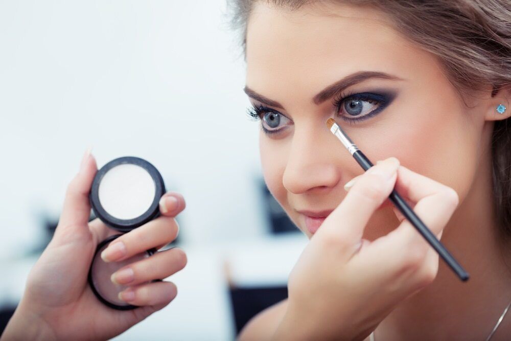 A Woman Is Getting Her Eye Makeup Done By A Makeup Artist — InHarmony Skin & Beauty Clinic In The Entrance, NSW