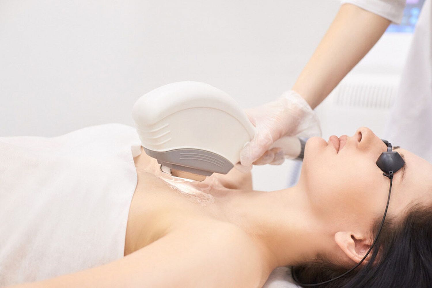 A Woman Is Getting A Laser Hair Removal Treatment On Her Chest — InHarmony Skin & Beauty Clinic In The Entrance, NSW