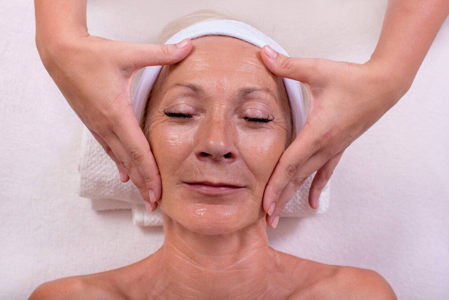An Older Woman Is Getting A Facial Massage At A Spa — InHarmony Skin & Beauty Clinic In The Entrance, NSW