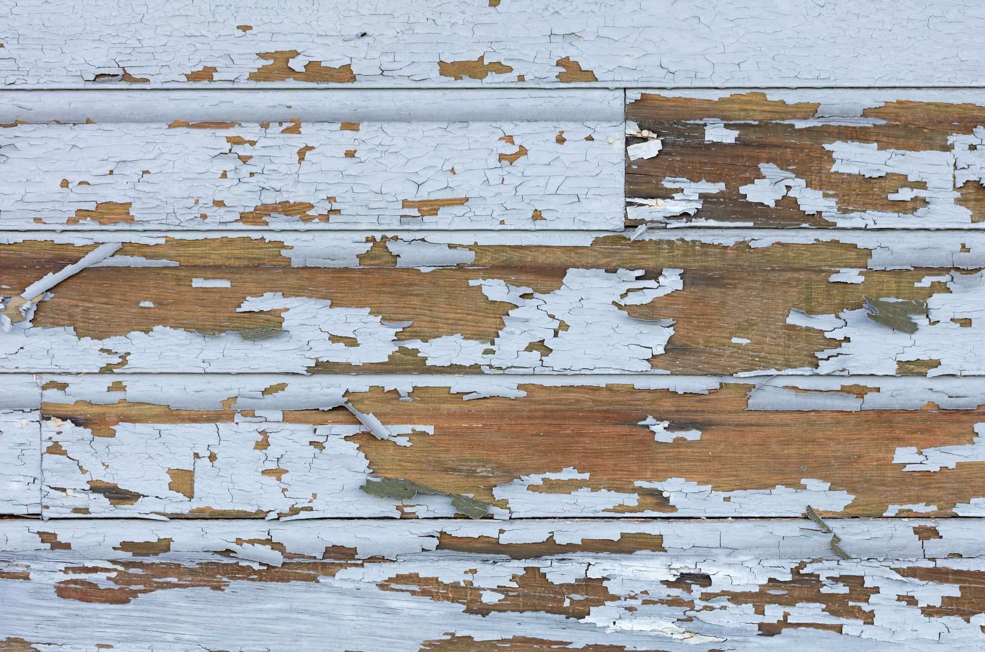 A close up of a wooden surface with peeling paint