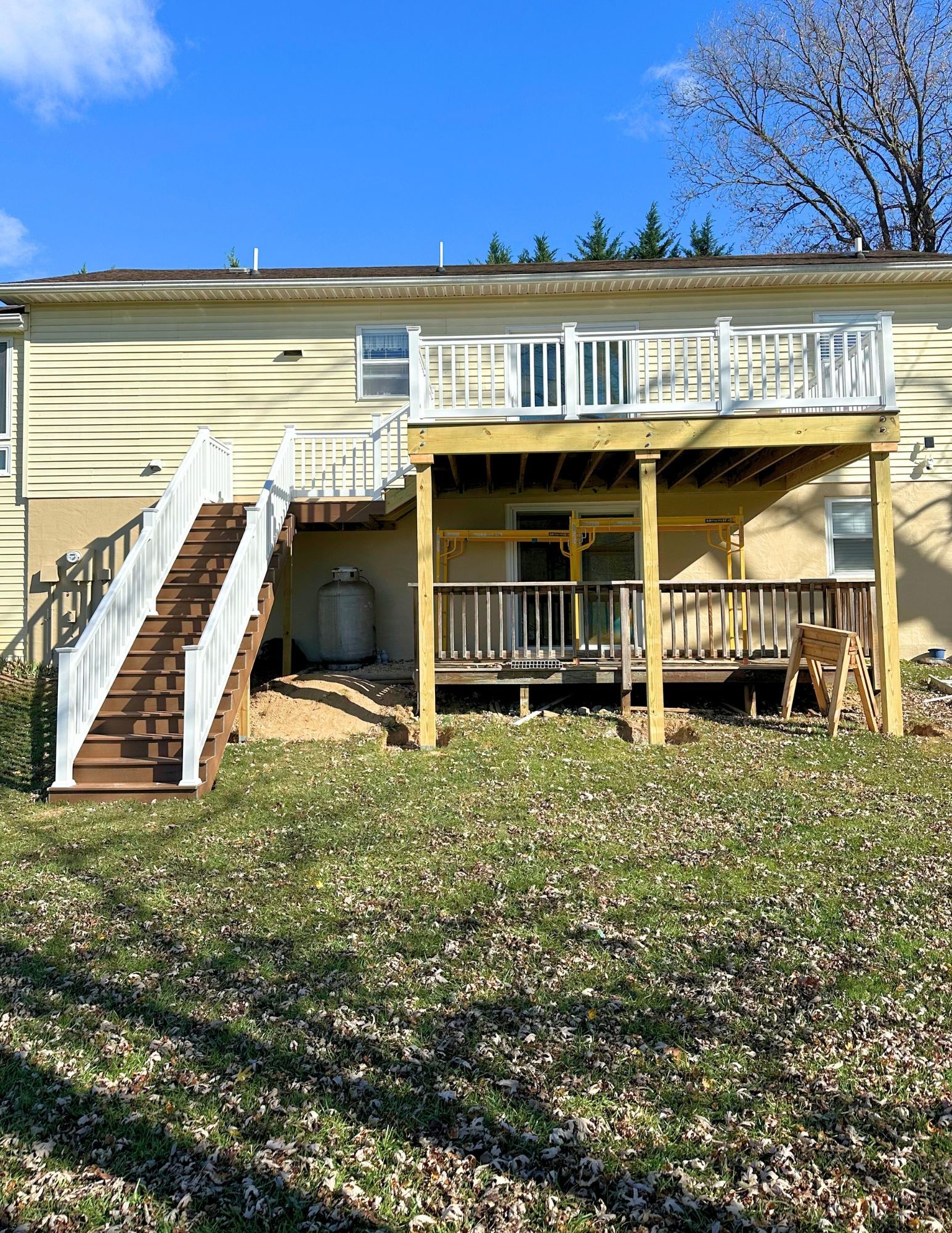 A large wooden deck with trees in the background