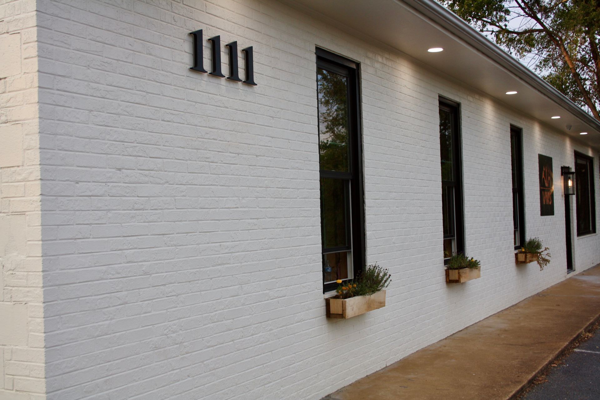 A white brick building with the number 1111 on it
