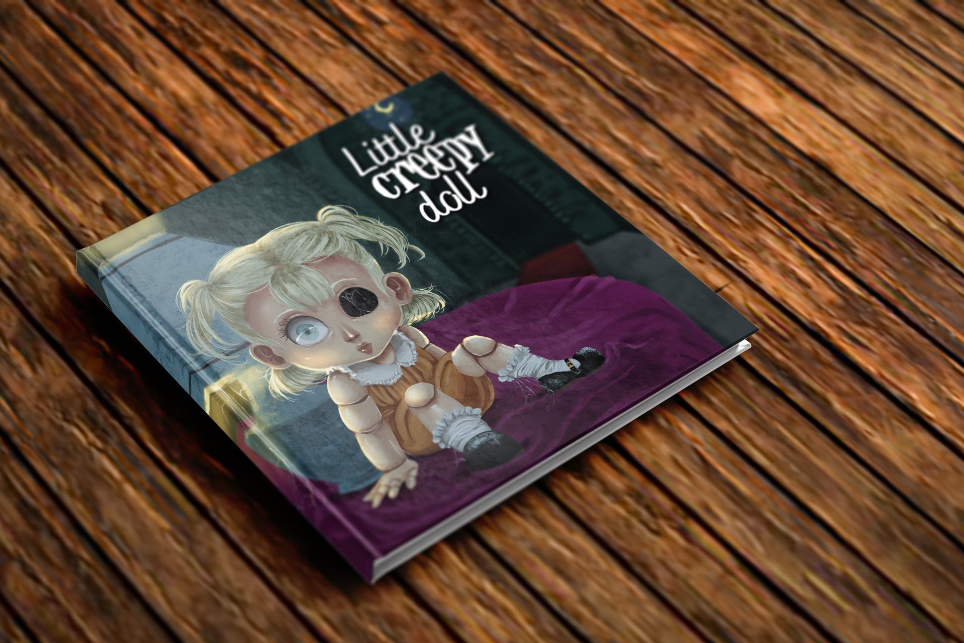 Un pequeño libro de muñecas espeluznantes está sobre una mesa de madera.